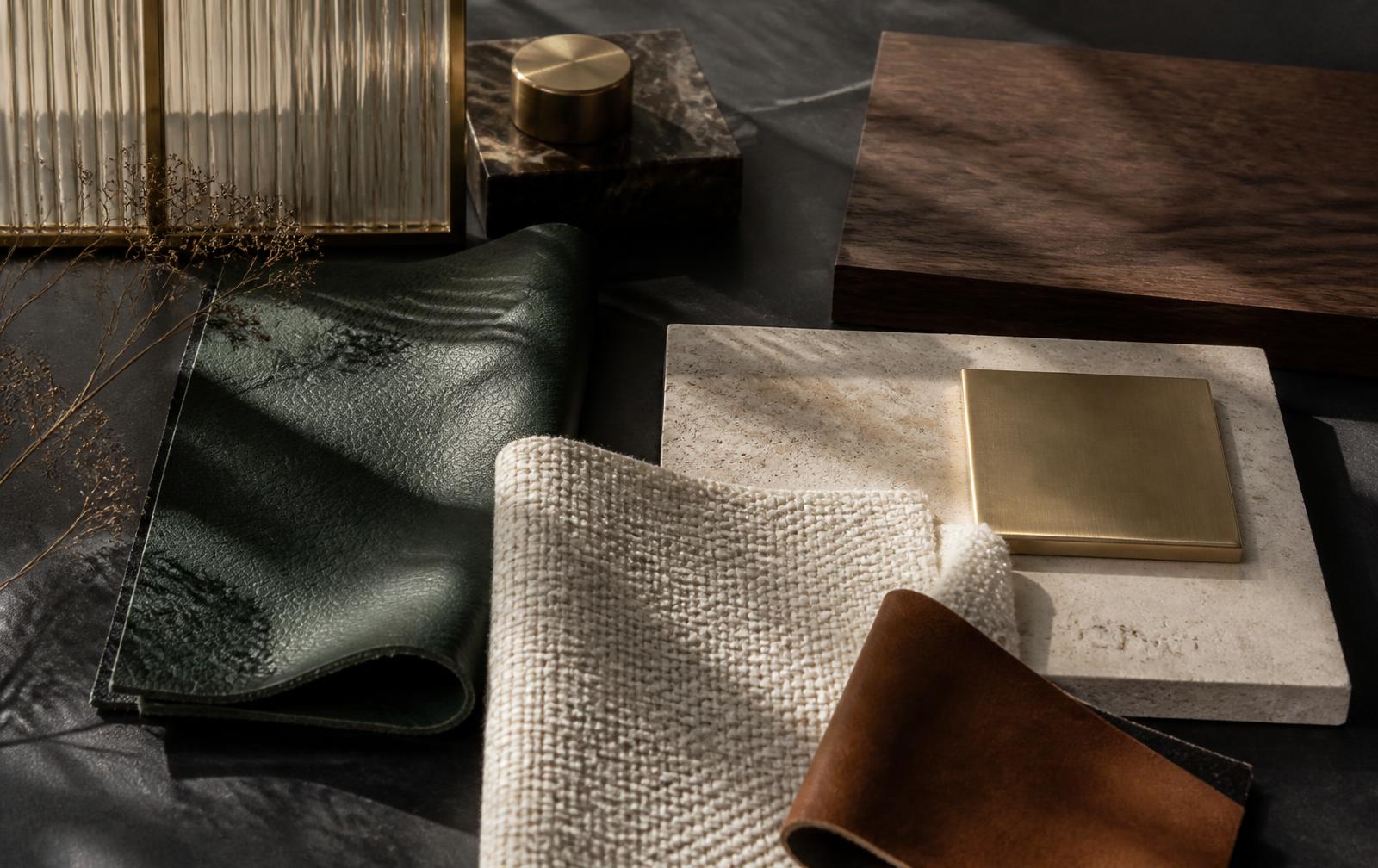 Concept material palette of green leather, ivory textile, stone, walnut and brass